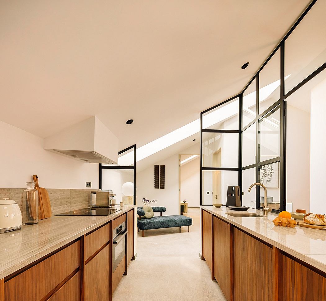 Sleek open-plan kitchen with large windows and wooden cabinetry.