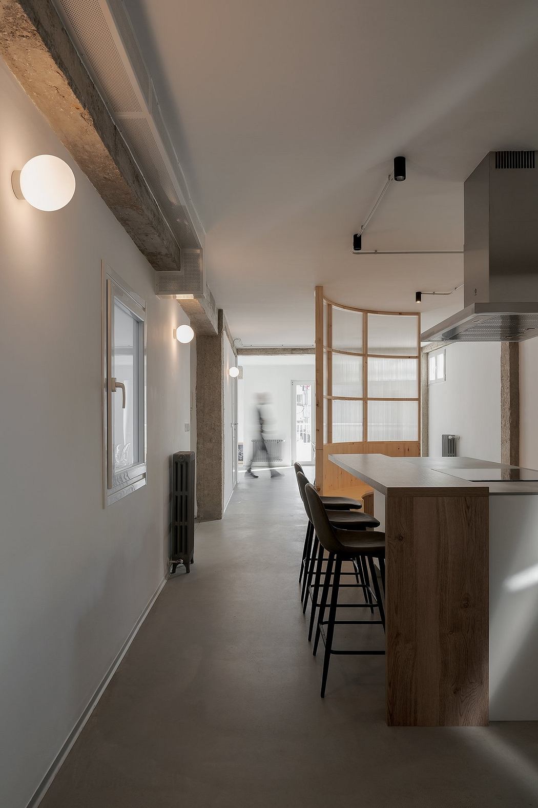 Modern interior with minimalist kitchen and sleek hallway lighting.