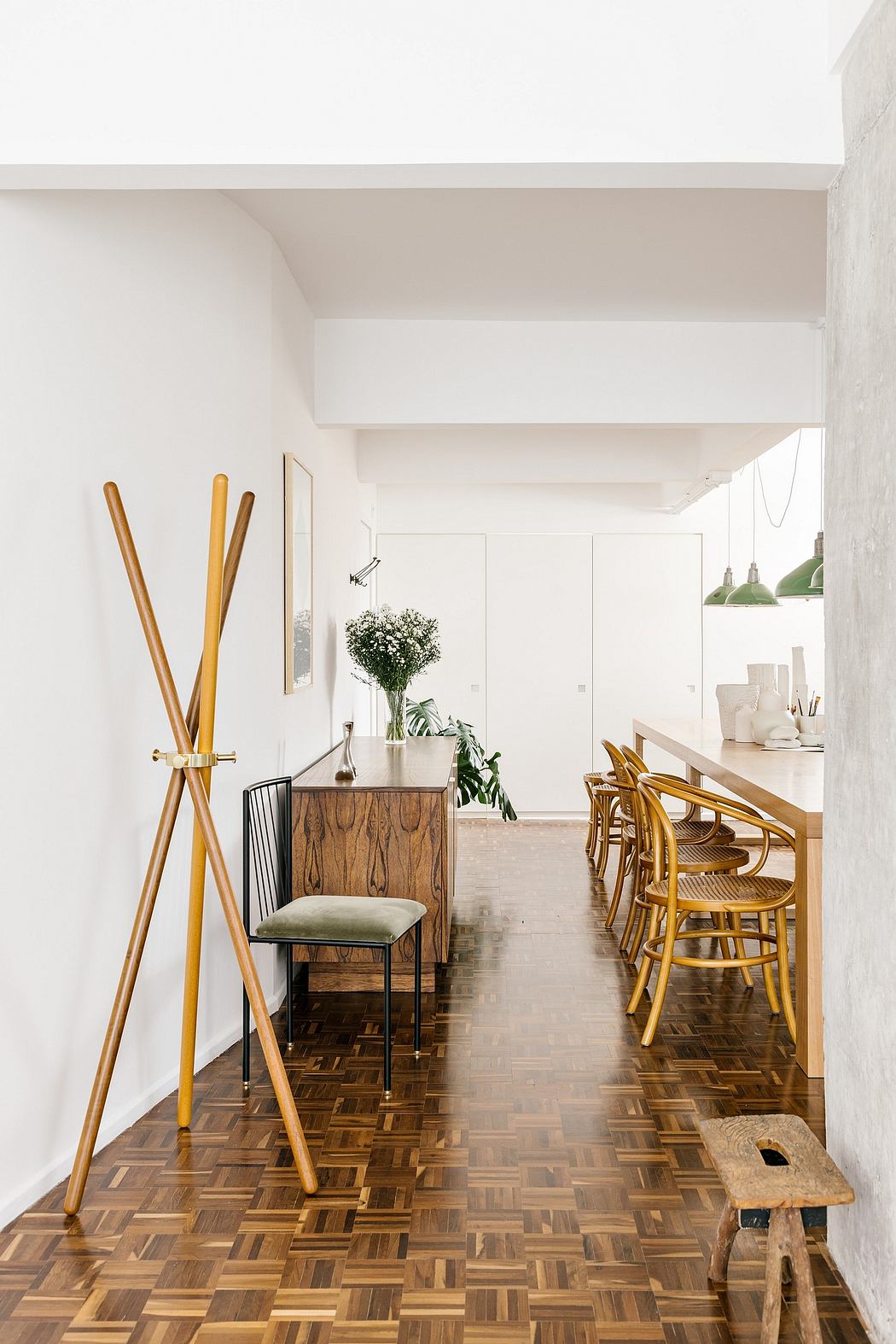 Modern hallway with herringbone floor and minimalist decor.