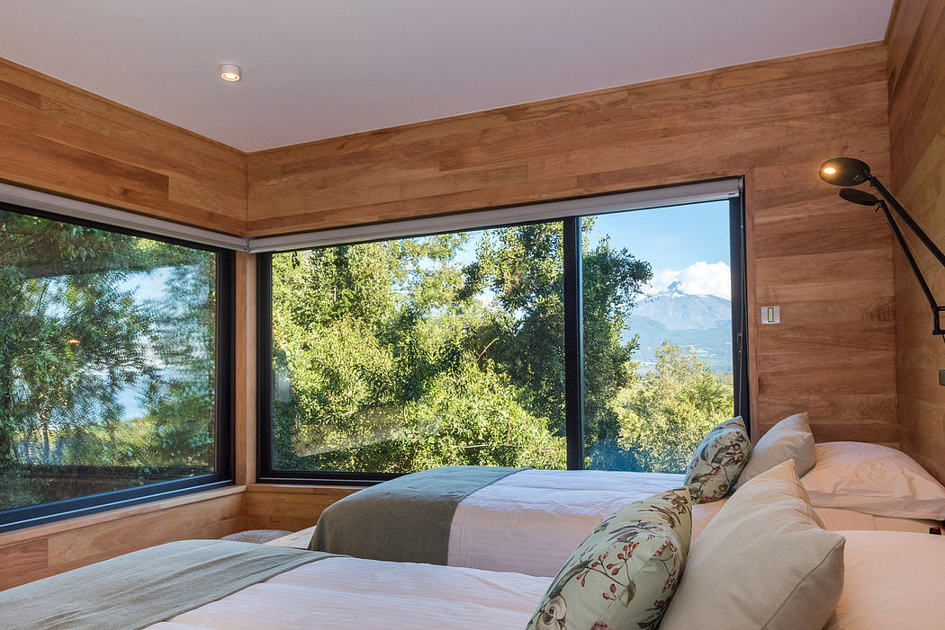 Wood-paneled bedroom with floor-to-ceiling windows and mountain view.