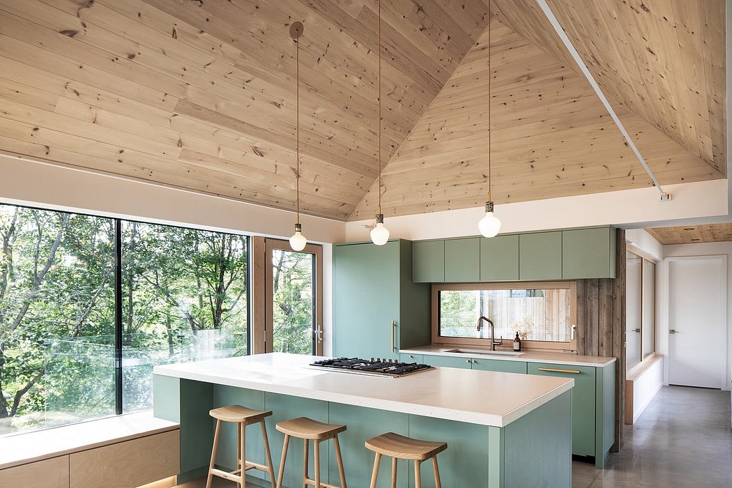 Modern kitchen with wooden ceiling, pendant lights, and a green island.