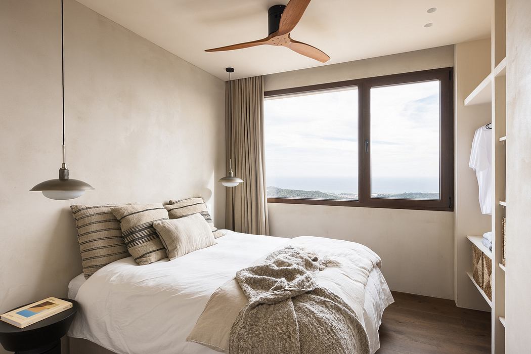Contemporary bedroom with neutral tones and ocean view.