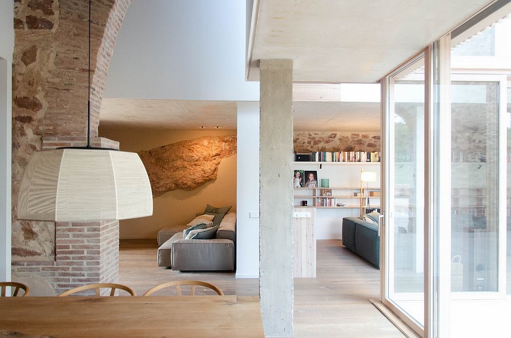 Modern interior with exposed brick, wooden floors, and large pendant lamp.