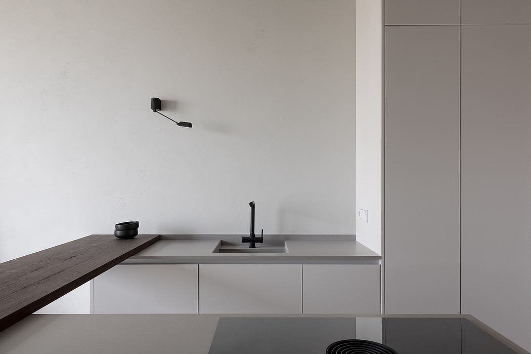 Minimalistic kitchen with sleek lines and neutral tones.