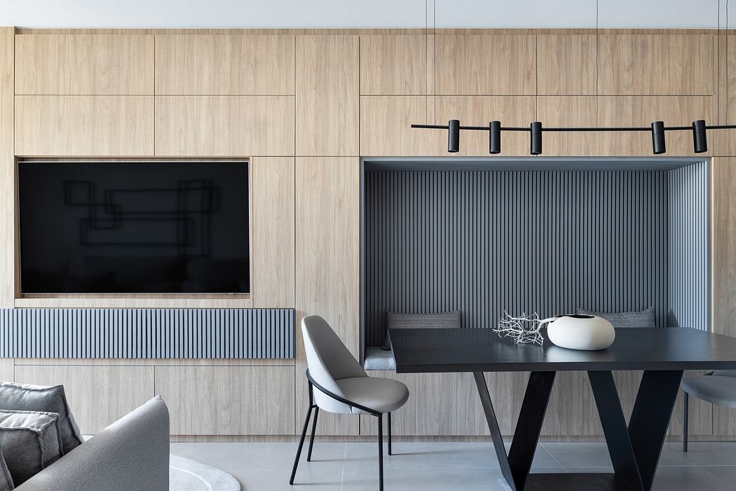 Contemporary dining area with minimalist wood panels and geometric furniture.
