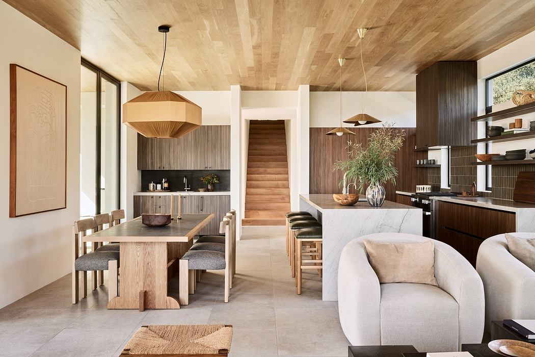 Modern open-plan living space with wooden furniture and neutral tones.