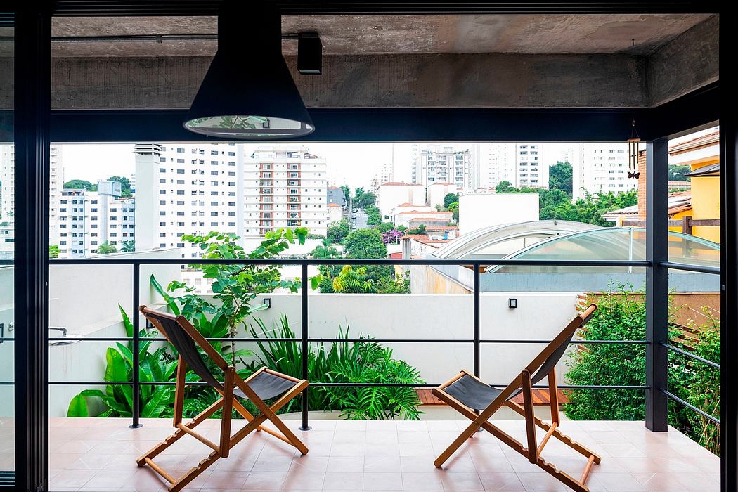 Urban balcony with sleek design, two chairs, and city view.