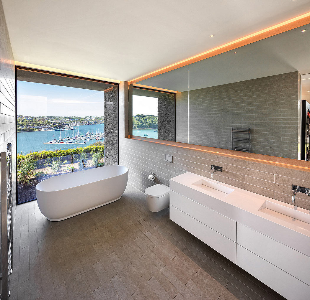 Sleek bathroom with ocean view and ambient lighting.