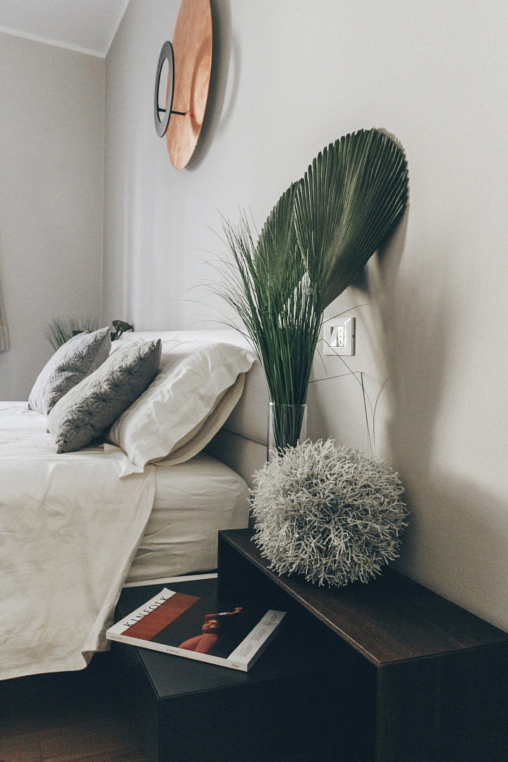 Contemporary bedroom corner with chic decor and plants.