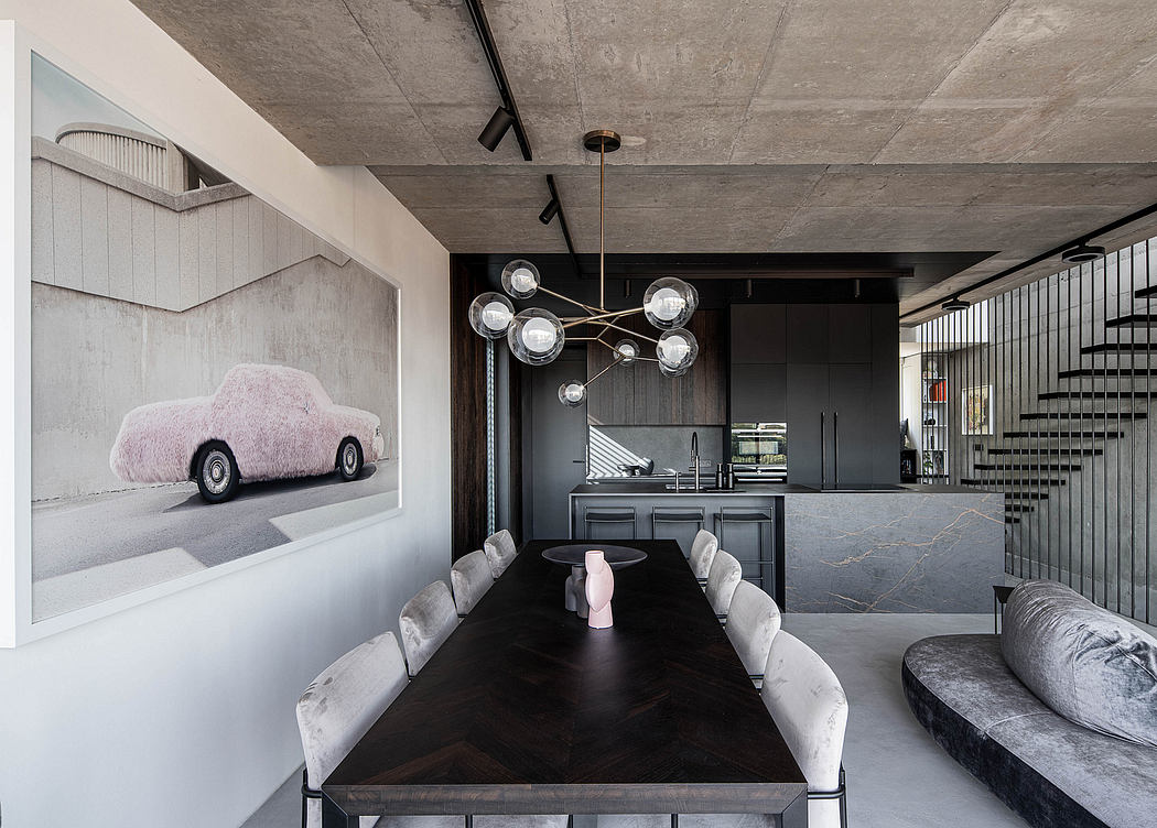 Modern dining room with dark wood table, bubble chandelier, and art.