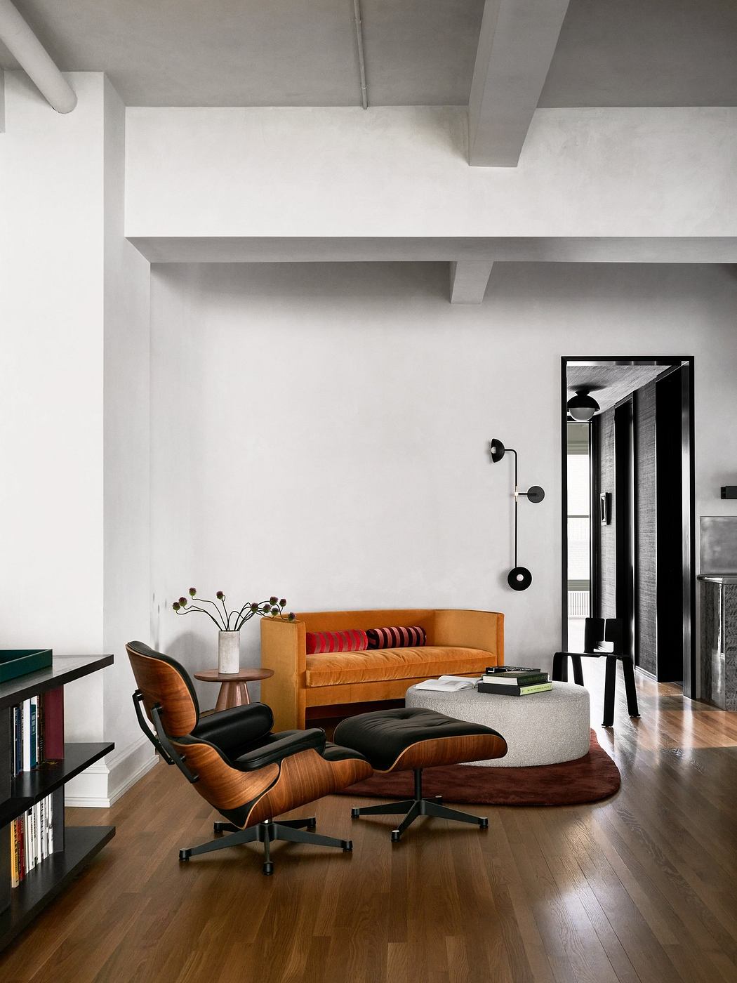 Sleek interior with a classic Eames chair, white walls, and polished
