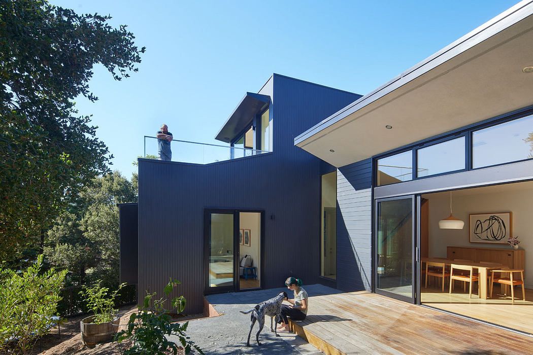 Contemporary house with large windows and wooden deck.
