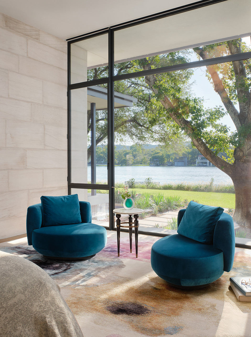 Elegant interior with two blue armchairs, floor-to-ceiling windows,