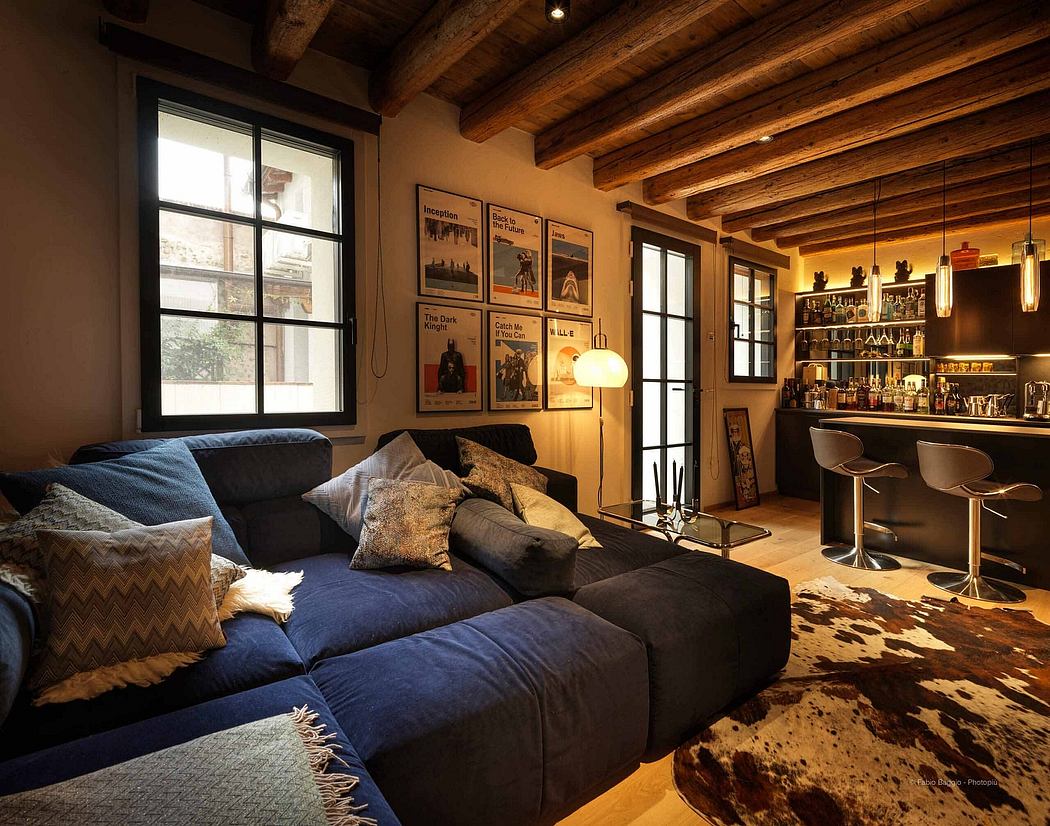Cozy living room with a large sofa, wooden ceiling, and a bar area