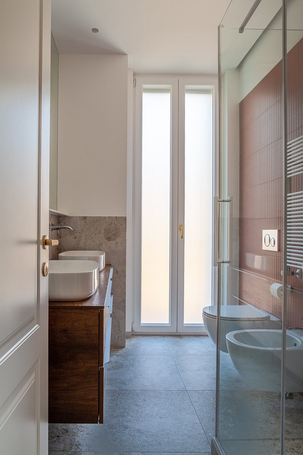 Contemporary bathroom with glass shower and wooden vanity.