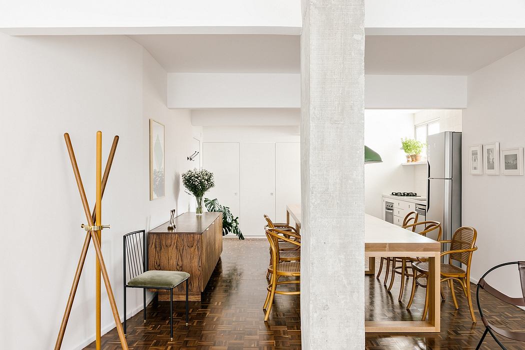 Modern dining room with wooden furniture and white walls.