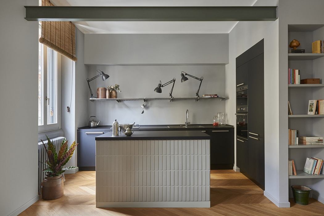 Contemporary kitchen with sleek cabinetry and herringbone floor.