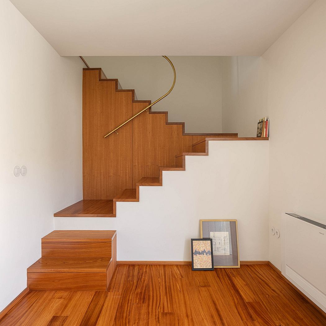 Sleek wooden staircase with minimalist design and curved handrail.