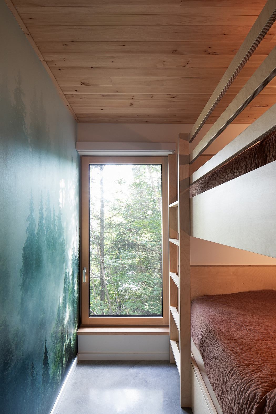 Modern bunk beds in a room with a wood ceiling, artistic wall, and window