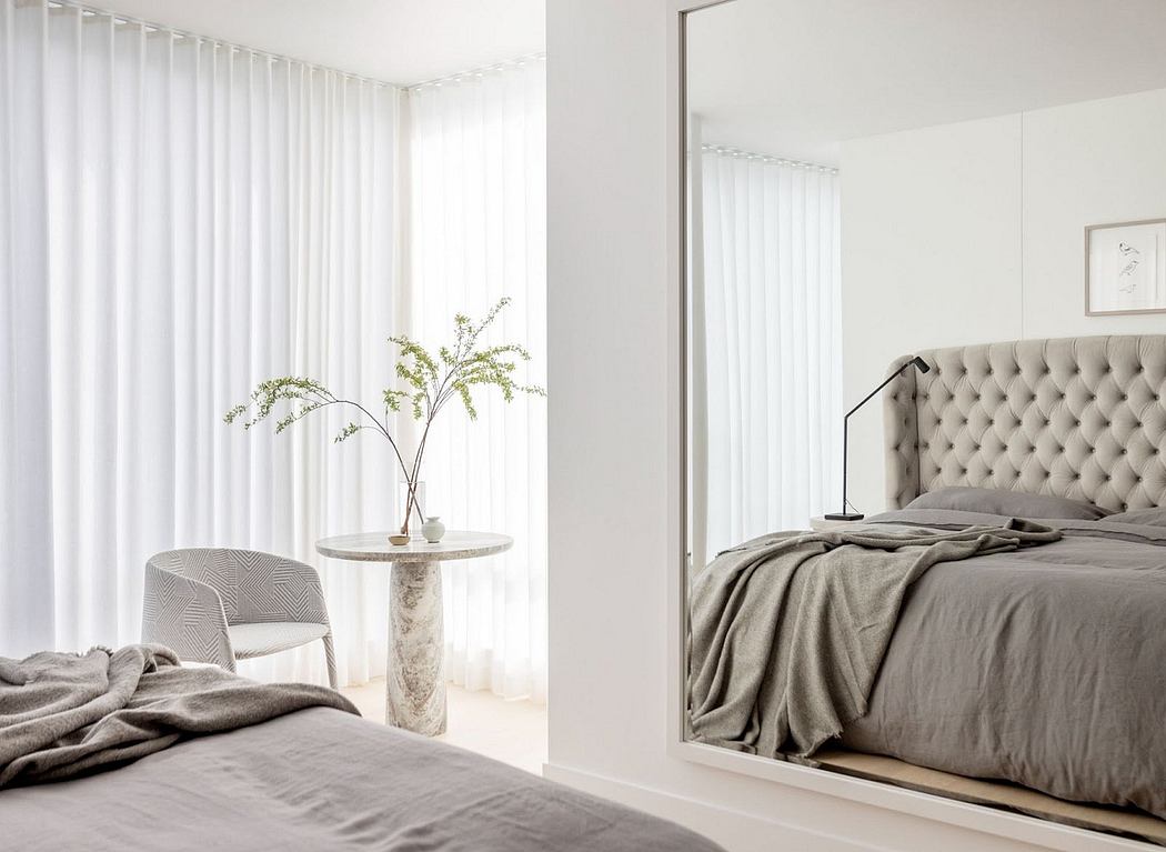 Minimalist bedroom with neutral colors and sheer curtains