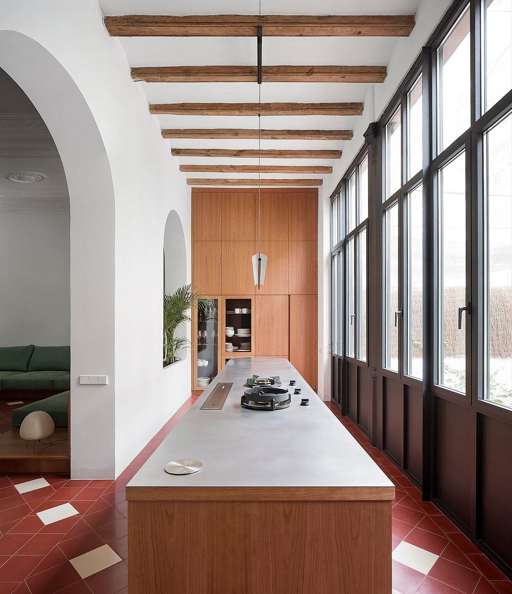 Bright, airy kitchen with high ceilings, wooden beams, and large windows.