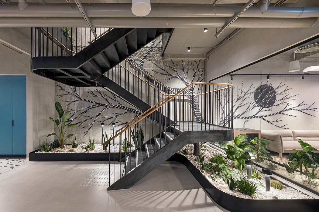 Chic interior with artistic staircase and lush greenery.