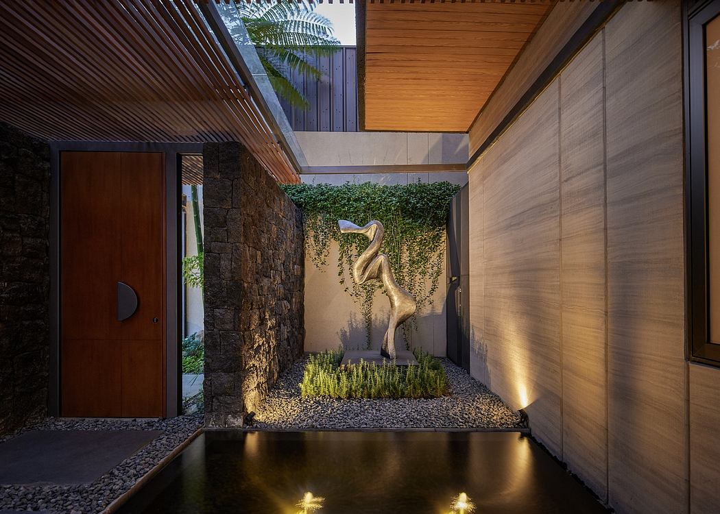 Contemporary courtyard with water feature and dinosaur sculpture.