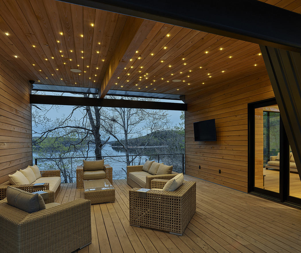 Wood-paneled lakeside lounge with starry ceiling lighting.