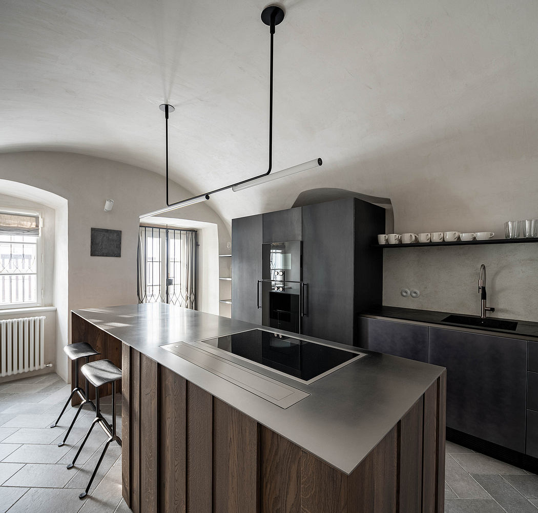 Minimalist kitchen with sleek dark cabinetry and wood accents.
