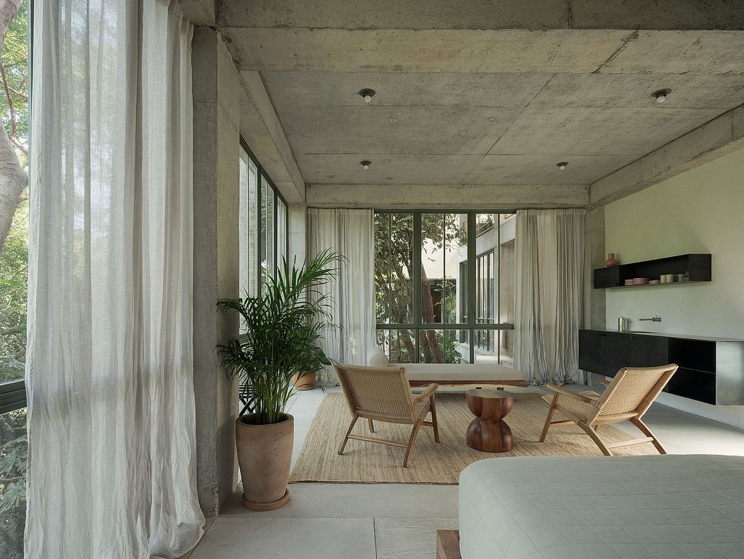 Minimalist living room with concrete walls and wooden furniture.