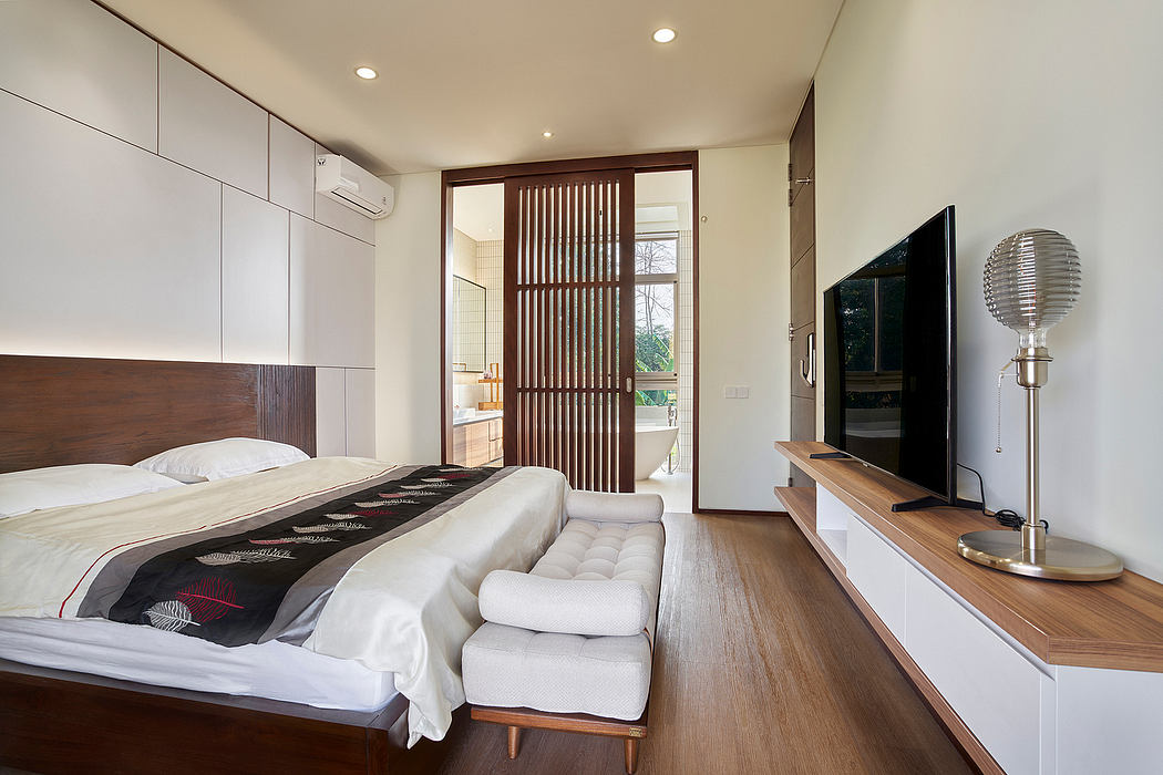 Contemporary bedroom with sleek furnishings and wooden accents.