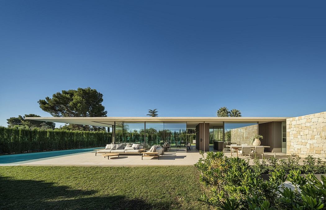 Sleek villa with pool, flat roof, and expansive glass doors.