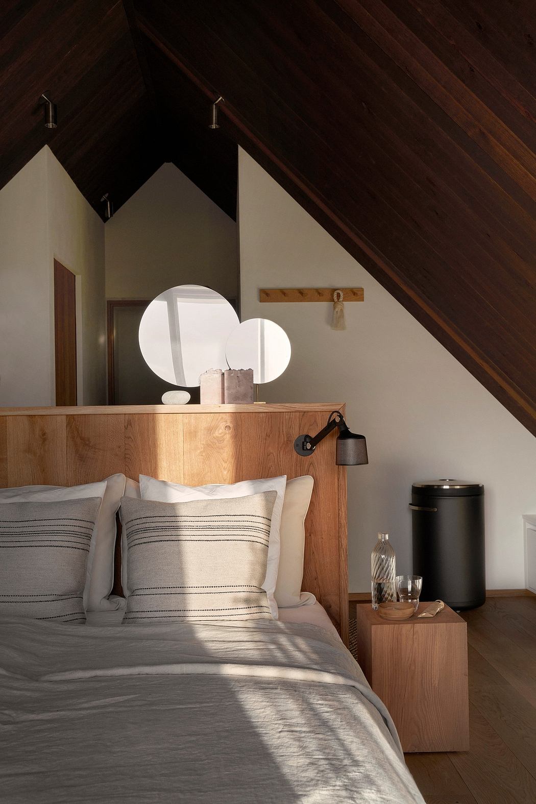 Cozy attic bedroom with wooden accents and minimalist decor.