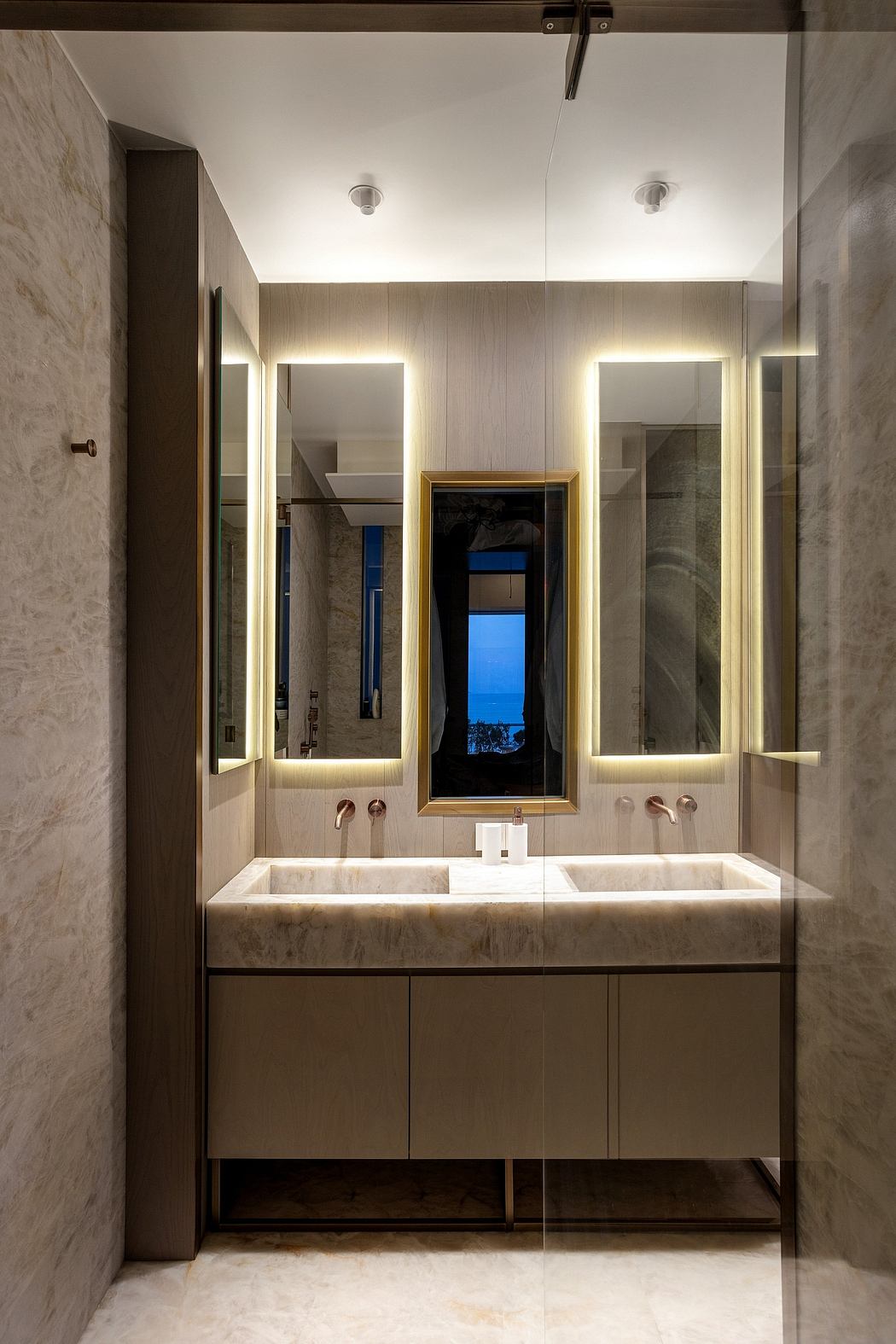 Modern bathroom with double sink and large mirrors.