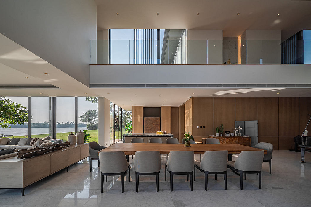 Spacious open-plan home interior with large windows overlooking nature.