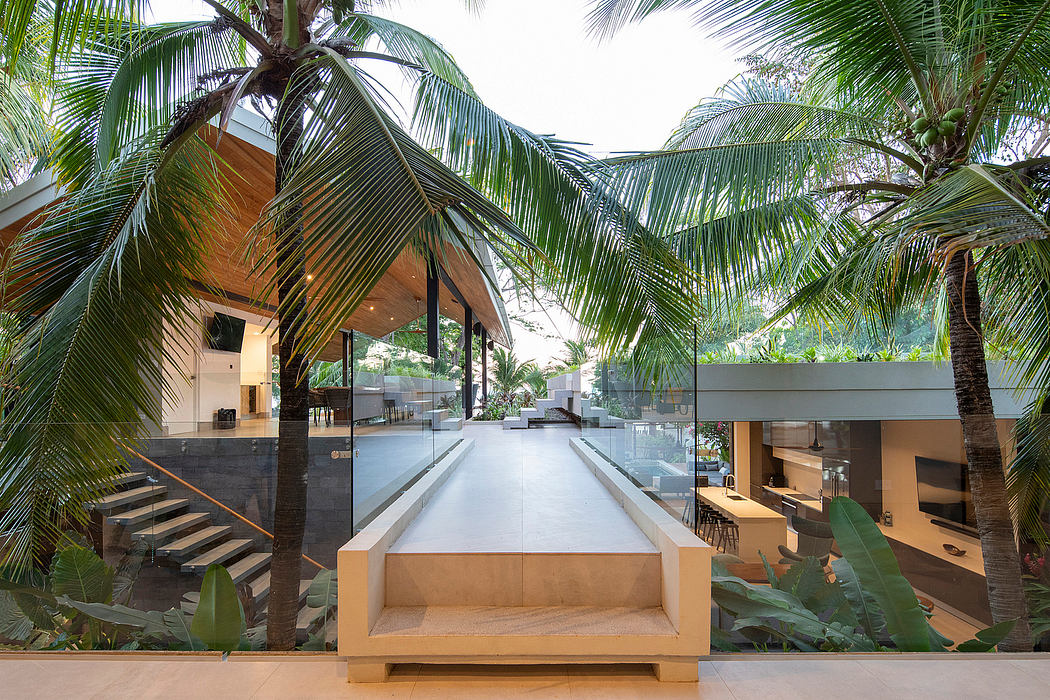 Open-concept home blending indoor/outdoor spaces with palm trees.