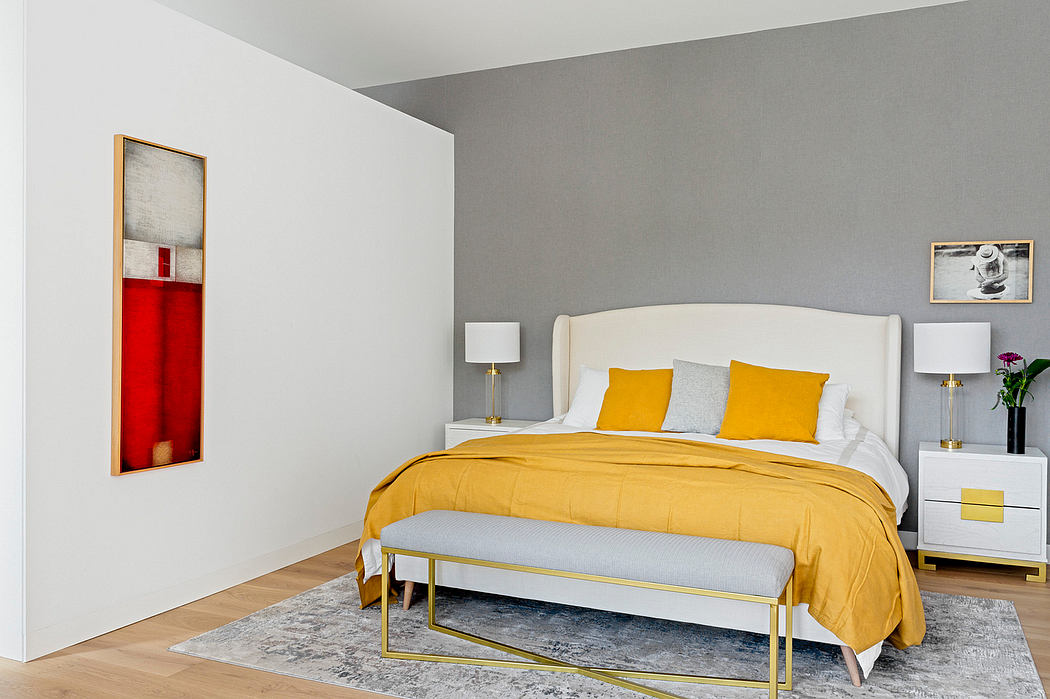 Contemporary bedroom with white and gray walls, accented by yellow bedding.