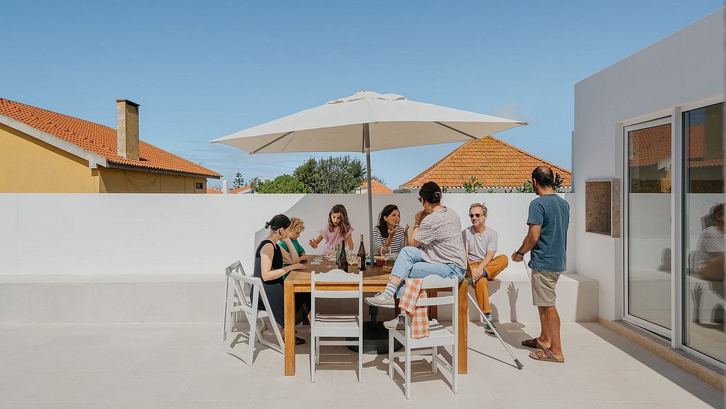 Contemporary rooftop terrace with a group of people around a dining table.