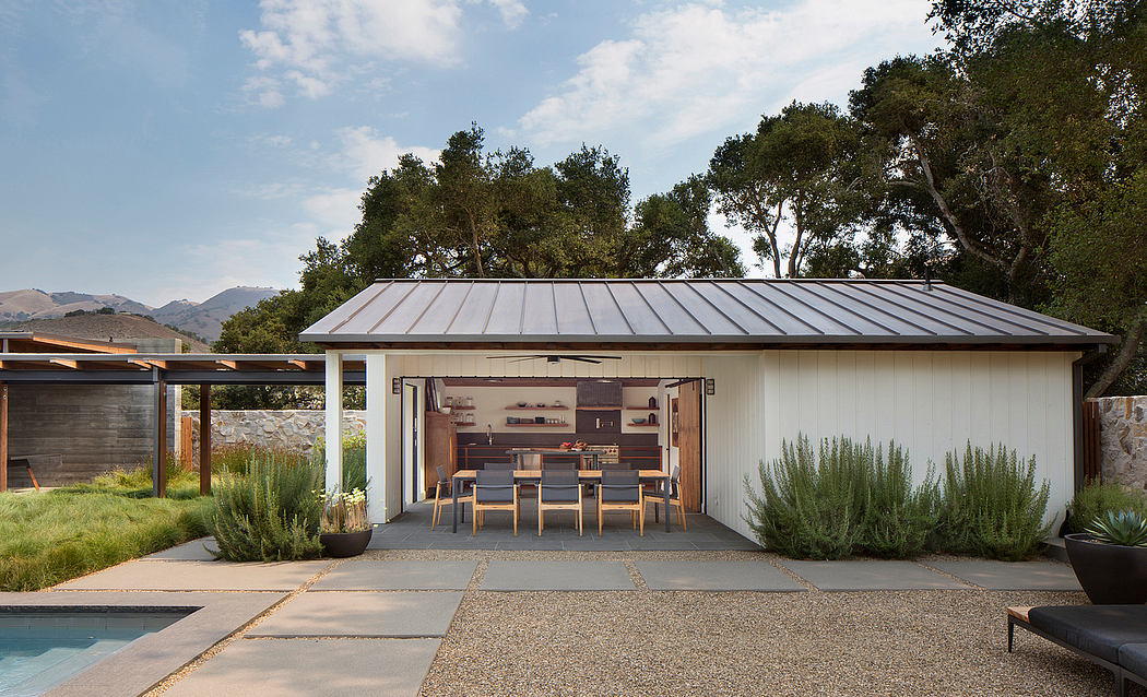 Modern home with open garage showcasing interior, surrounded by nature.