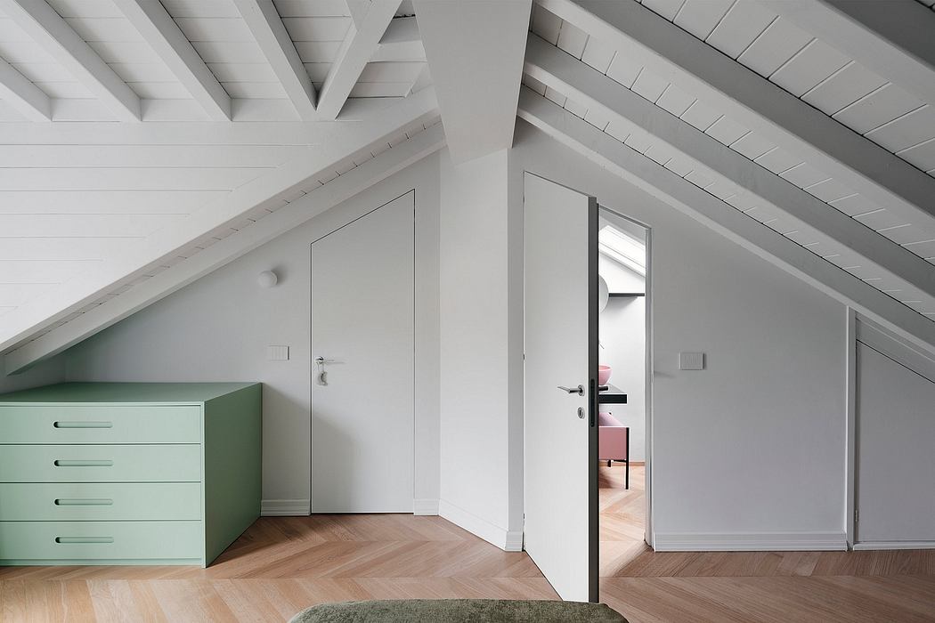 Contemporary attic room with sloped ceilings and minimalist design.