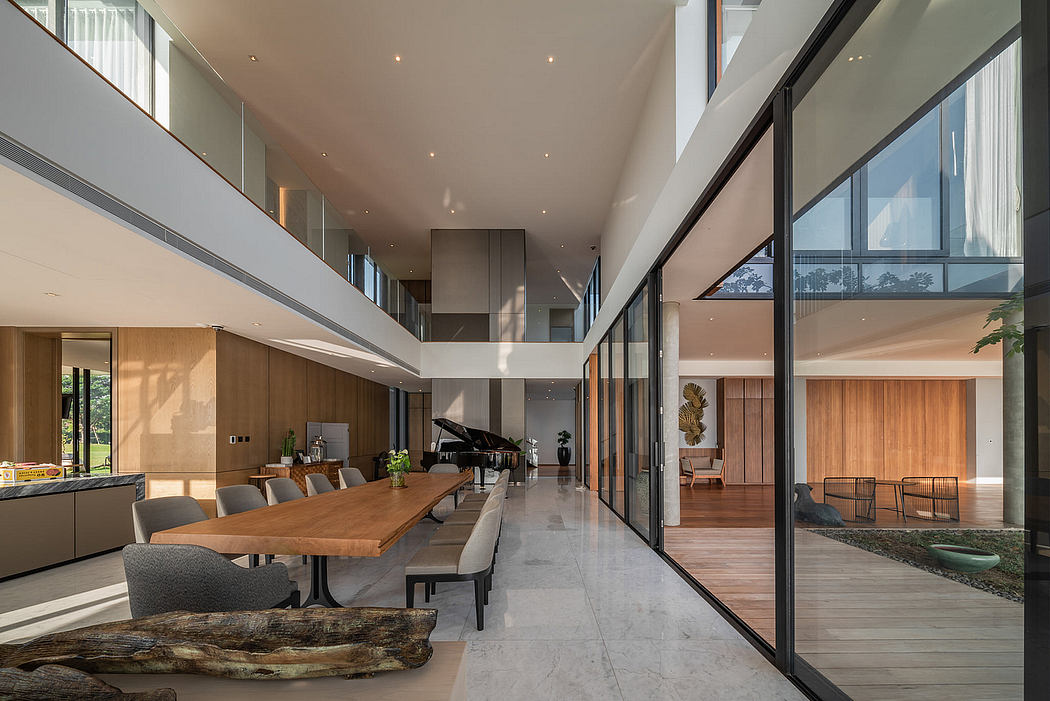 Spacious modern interior with high ceilings, large windows, and minimalist furniture.