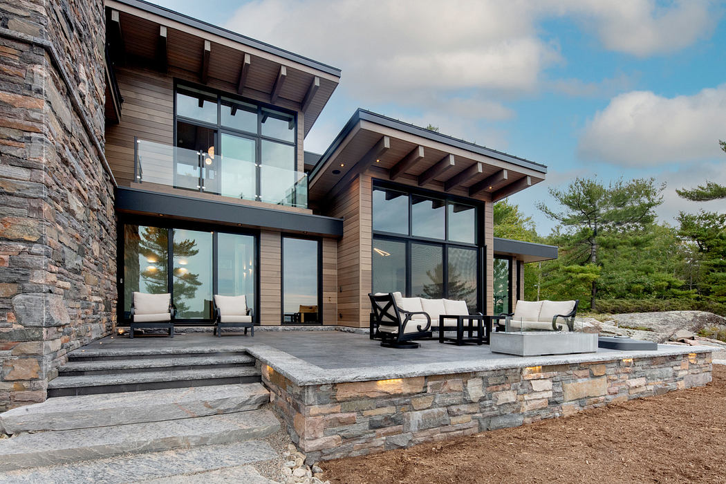 Contemporary house with large windows and stone accents.