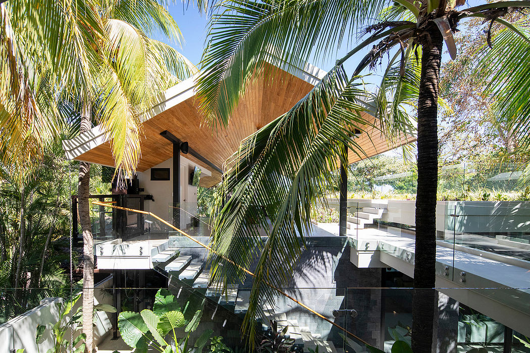 Modern house with wooden overhangs surrounded by lush greenery.