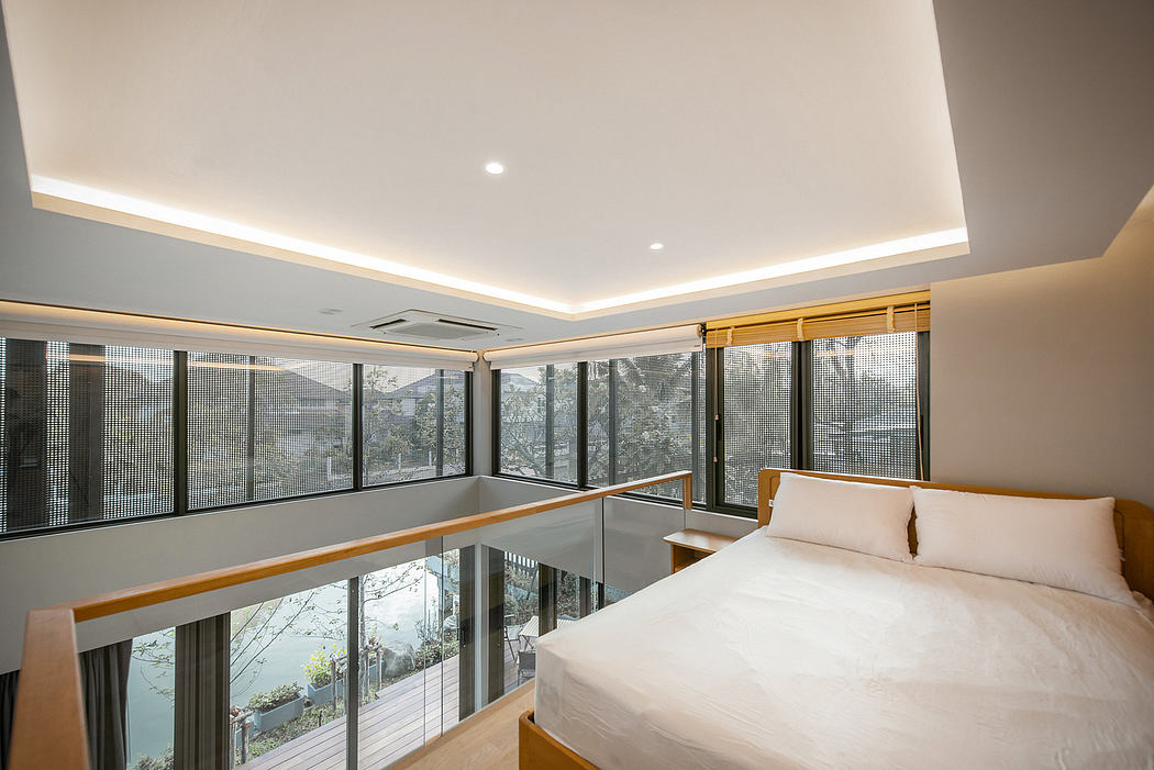 Contemporary bedroom with large windows and indirect ceiling lighting.