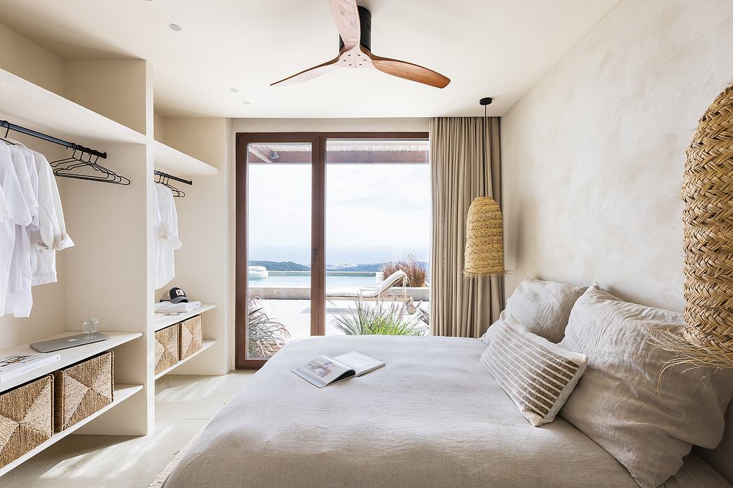 Modern beachfront bedroom with neutral tones and ocean view.