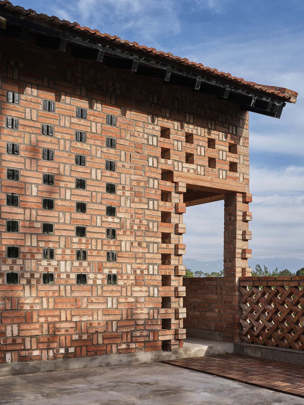 Brick building with unique geometric patterns and an open window.