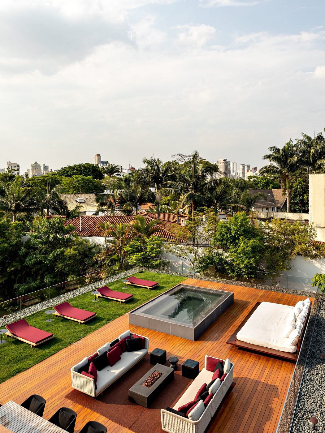 Rooftop terrace with chic lounge area overlooking a cityscape.