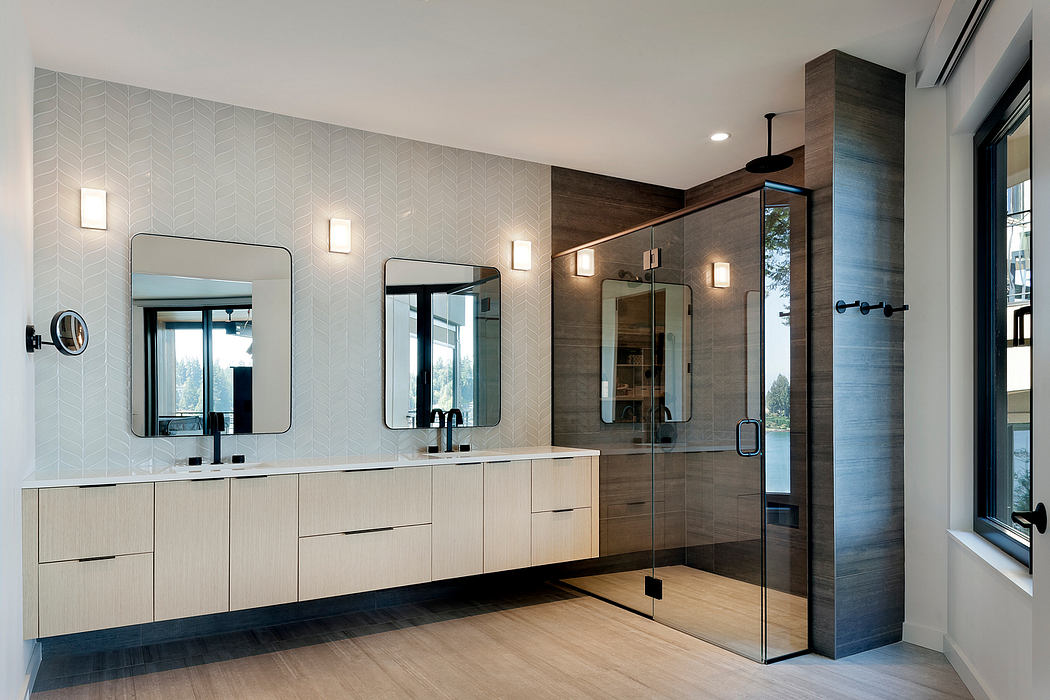 Modern bathroom with double vanity and glass shower enclosure.