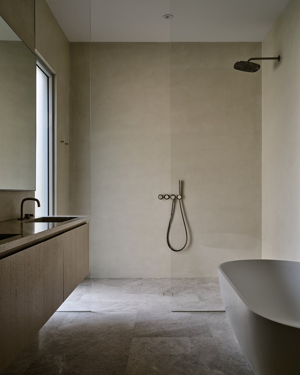 Modern minimalist bathroom with beige tiles, bathtub, and wall-mounted shower.