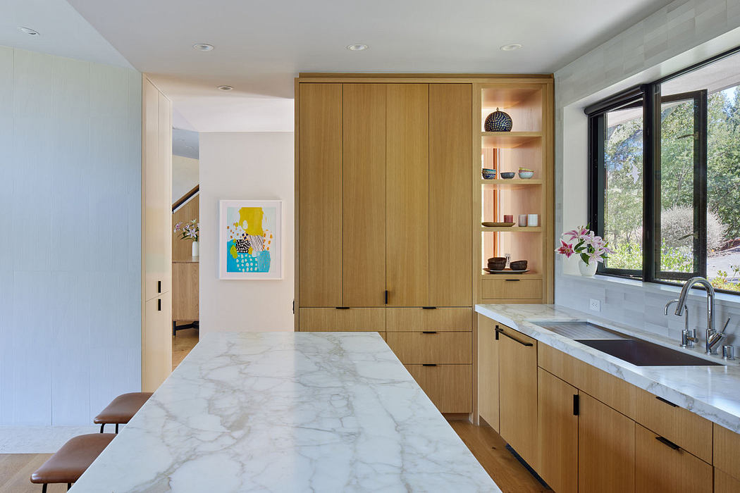 Contemporary kitchen with marble countertops and wooden cabinetry.